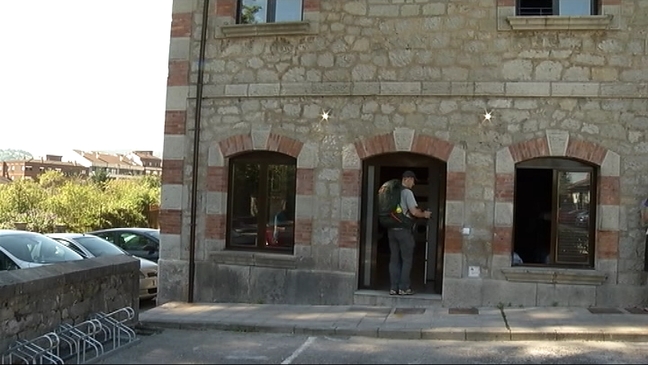 Un peregrino entra en el albergue Villa de Grado